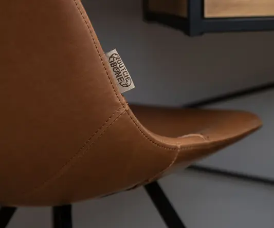 a brown chair with a black metal frame