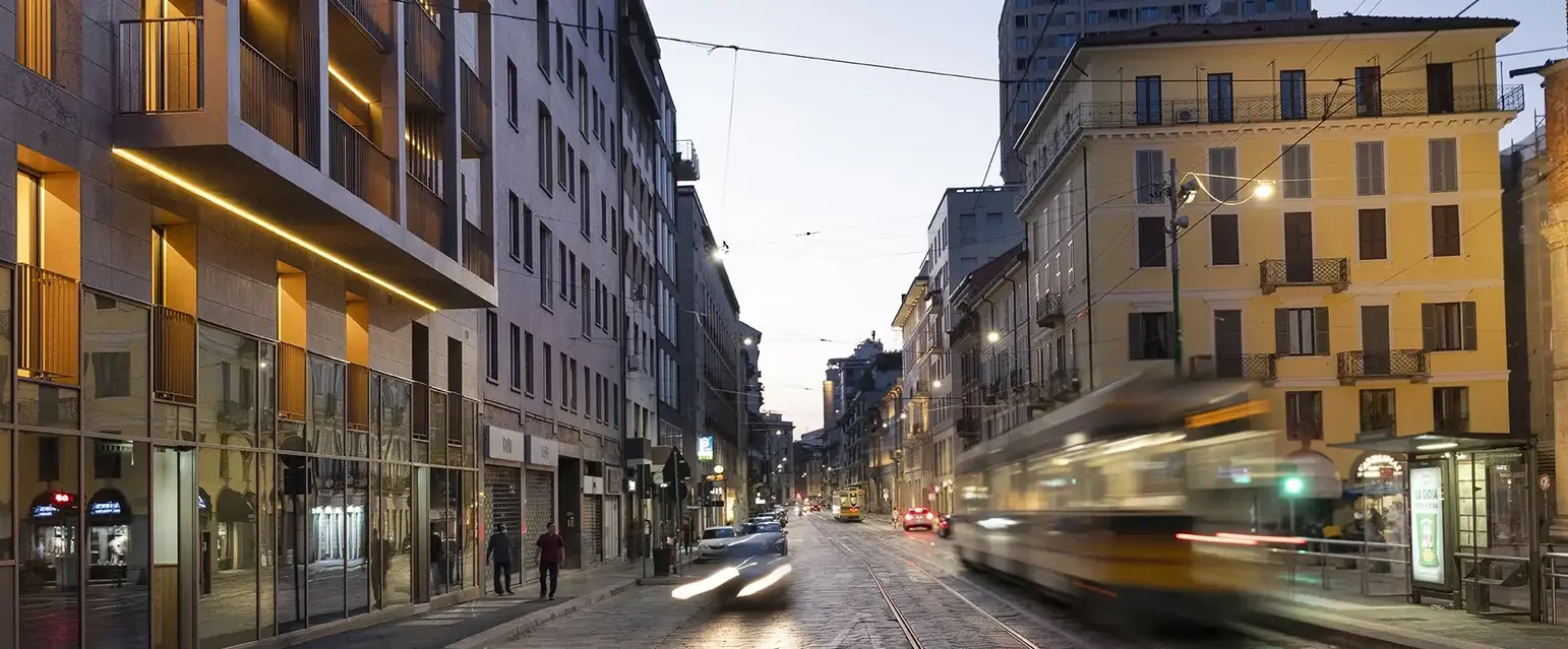 a street with buildings and a train moving on it
