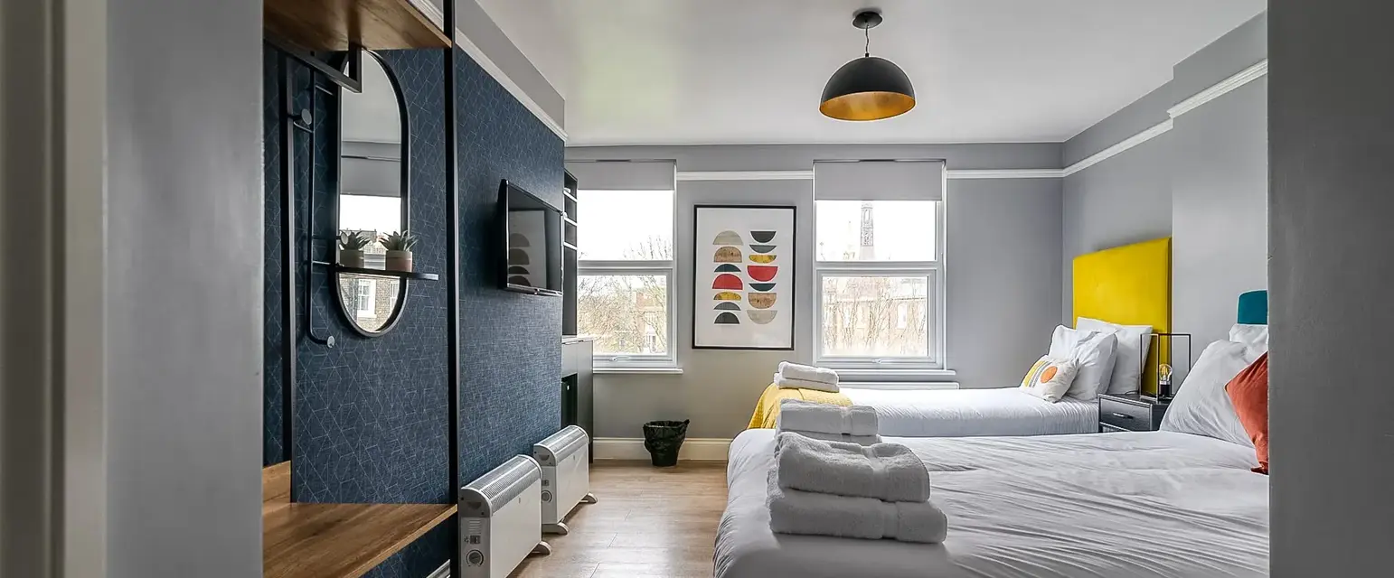 a room with two beds and a tv