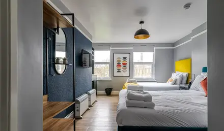 a room with two beds and a tv