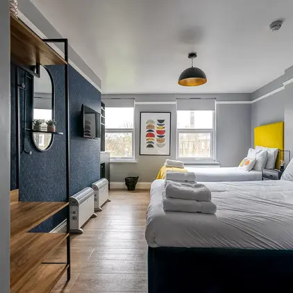 a room with two beds and a tv