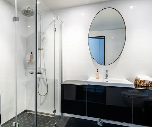 a bathroom with a shower and a washing machine