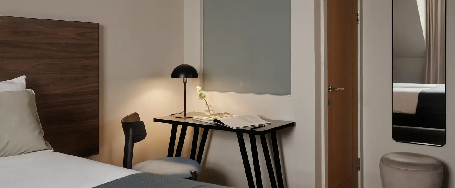 a bedroom with a bed and a desk