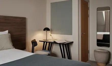 a bedroom with a bed and a desk