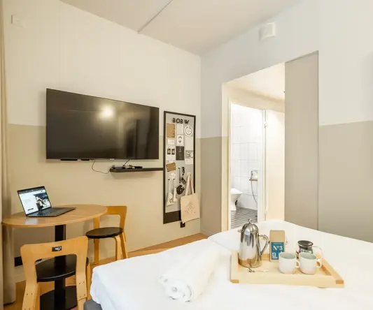 a room with a bed and a tv