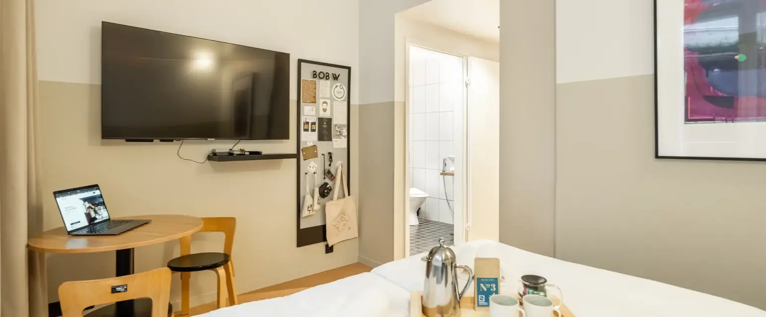 a room with a bed and a tv