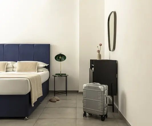 a suitcase next to a bed