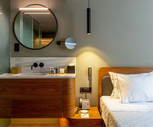 a bathroom with a mirror and a bed