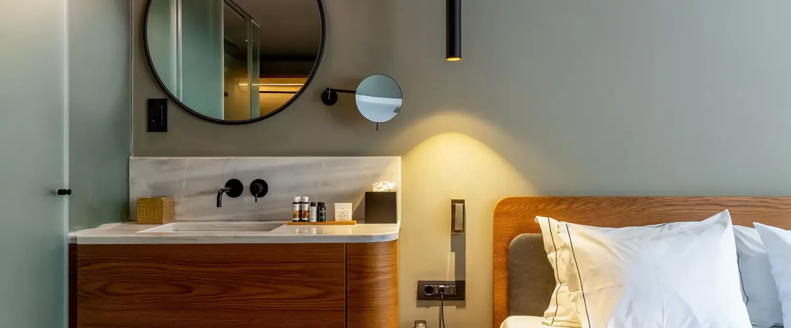 a bathroom with a mirror and a bed