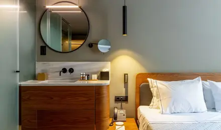 a bathroom with a mirror and a bed