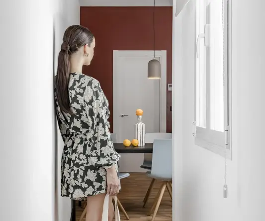 a woman in a dress holding a bag