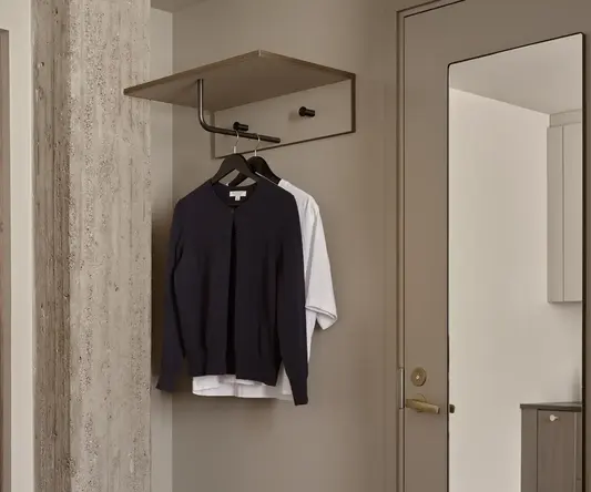 a closet with a shirt and a mirror