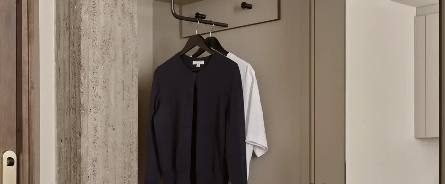 a closet with a shirt and a mirror