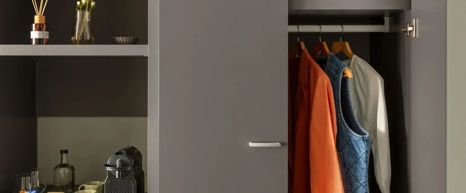 a closet with clothes and a bag