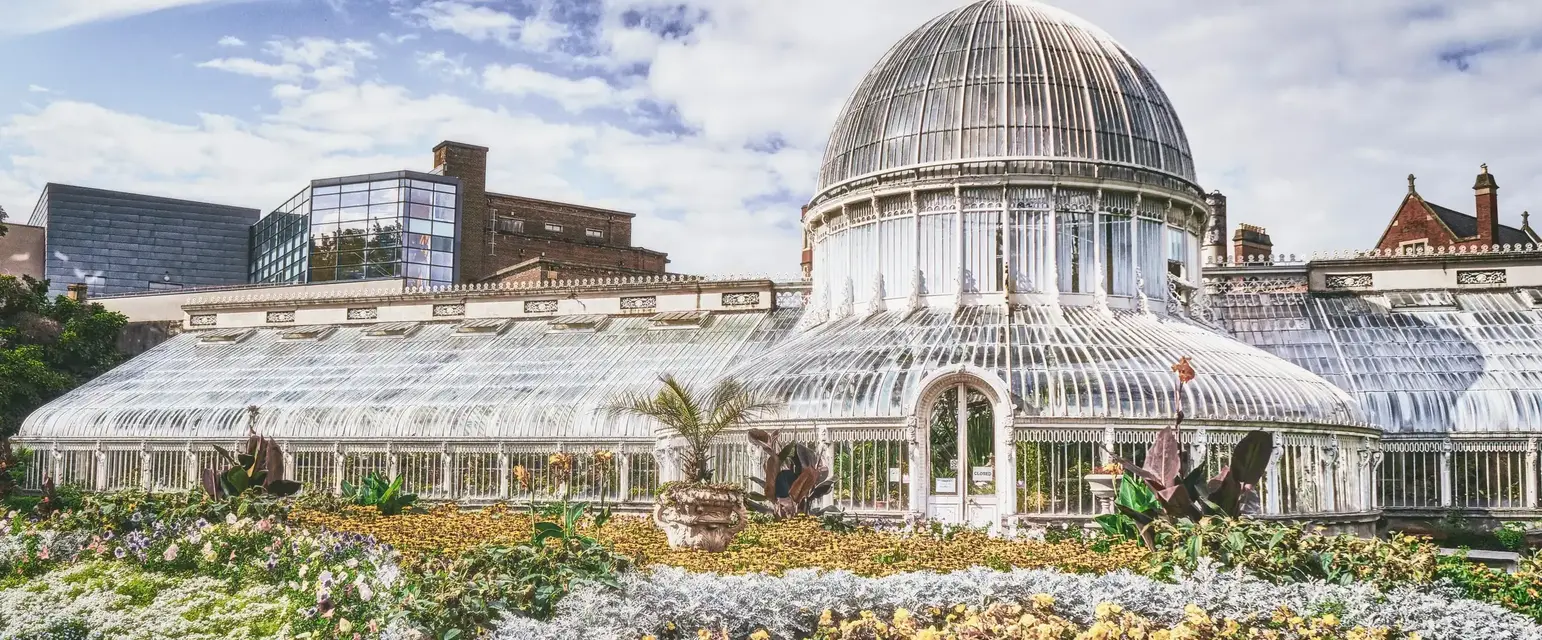 a large glass building with a dome roof and a garden. Photo by K. Mitch Hodge on Unsplash
