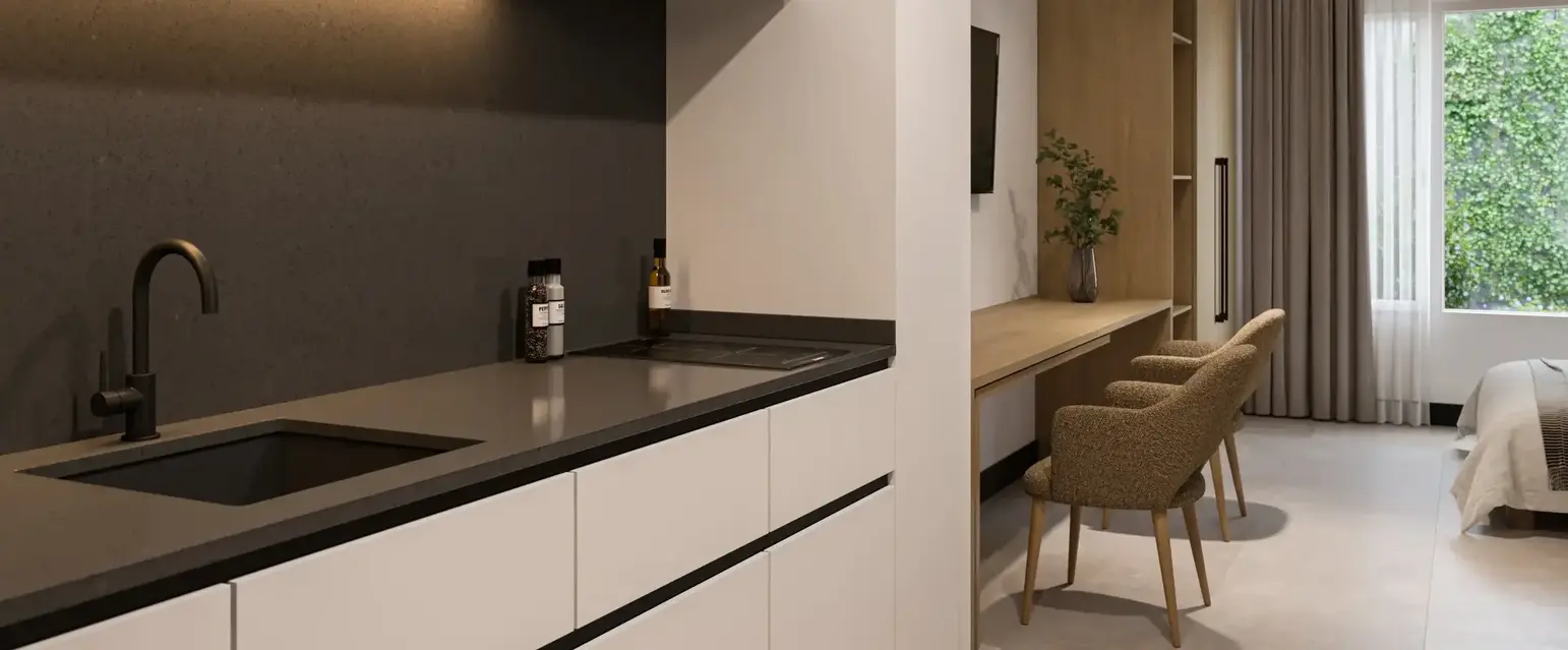 a kitchen with a microwave and a bed