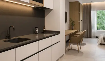 a kitchen with a microwave and a bed