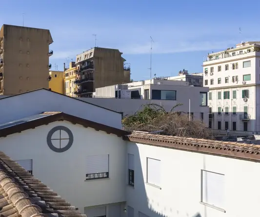 a rooftop of a building with many buildings in the background