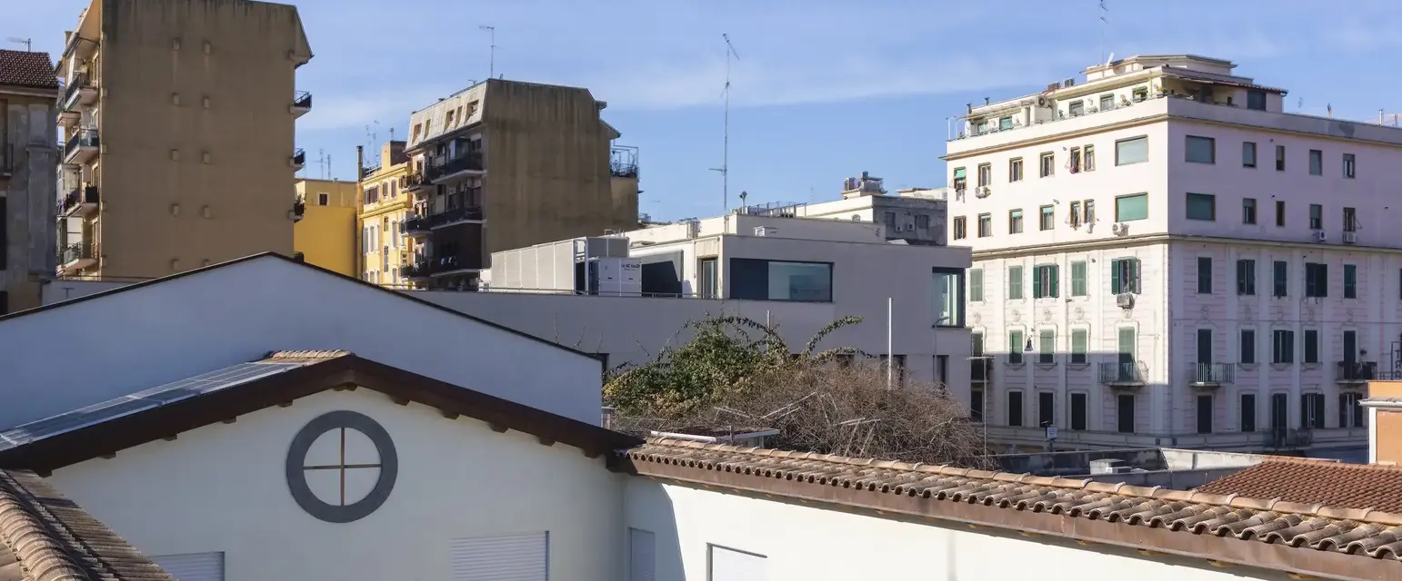 a rooftop of a building with many buildings in the background