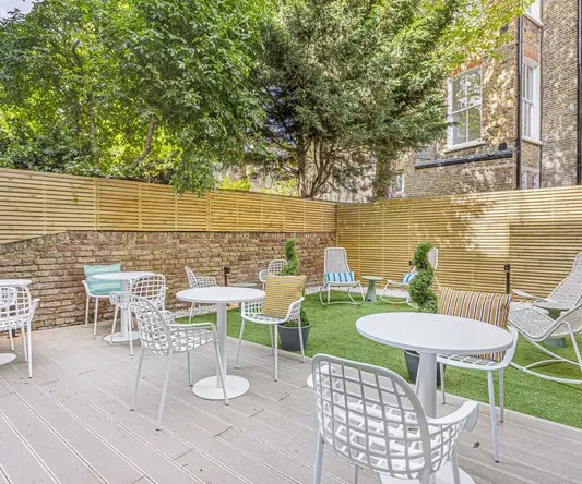 a patio with chairs and tables