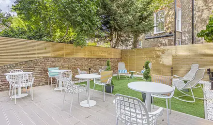 a patio with chairs and tables