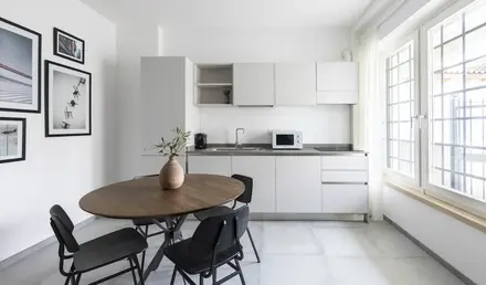 a kitchen with a table and chairs