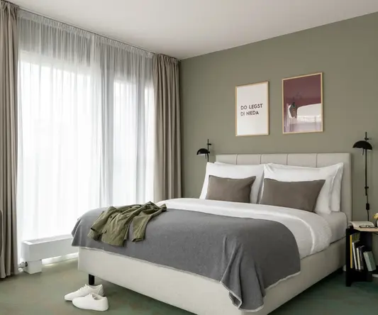 a bed with pillows and a pair of shoes on it