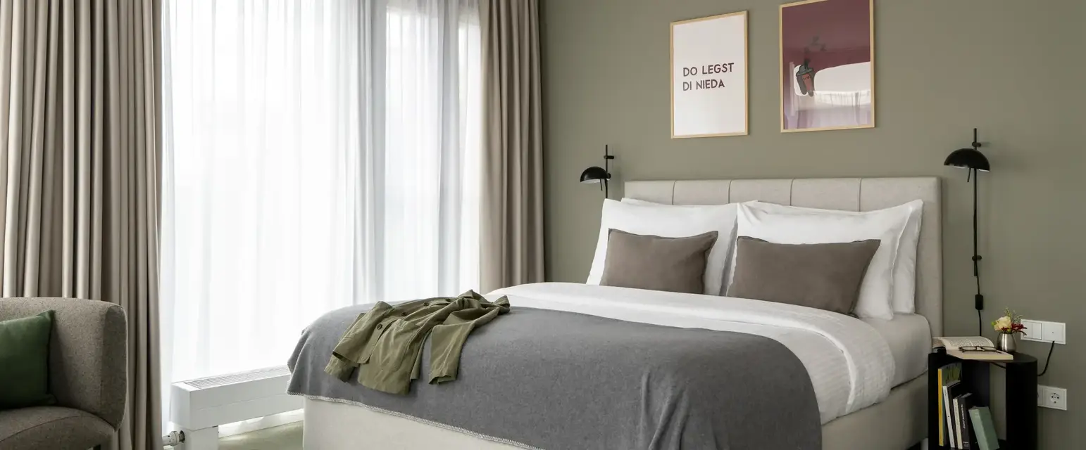 a bed with pillows and a pair of shoes on it