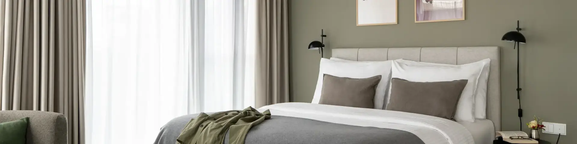 a bed with pillows and a pair of shoes on it