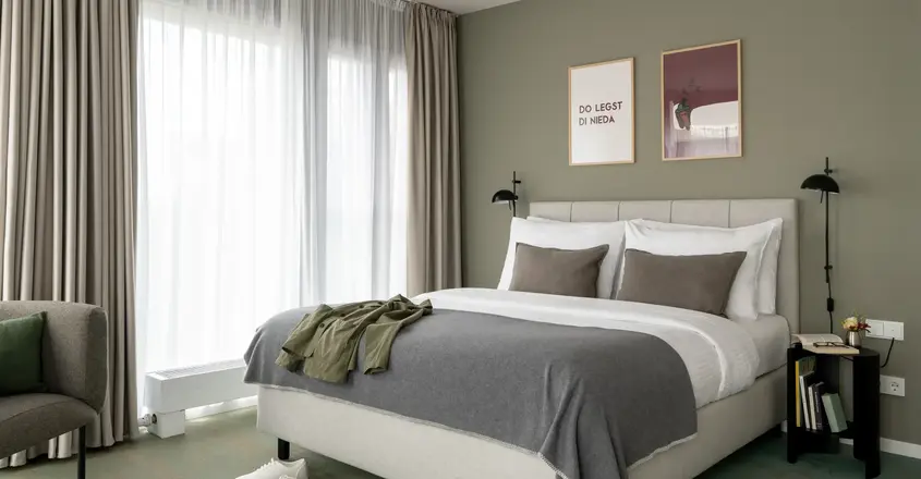a bed with pillows and a pair of shoes on it