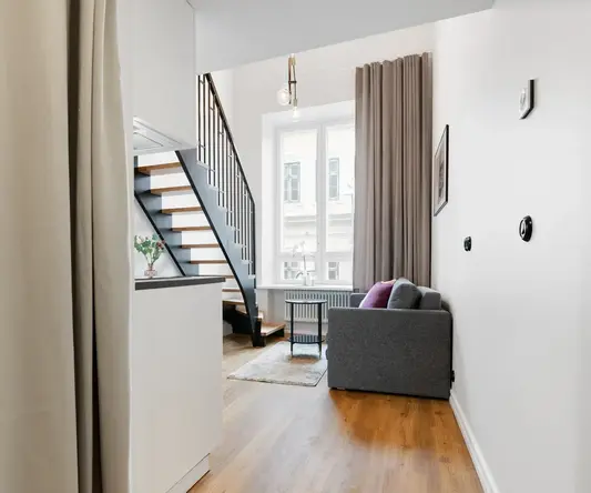 a room with a couch and stairs