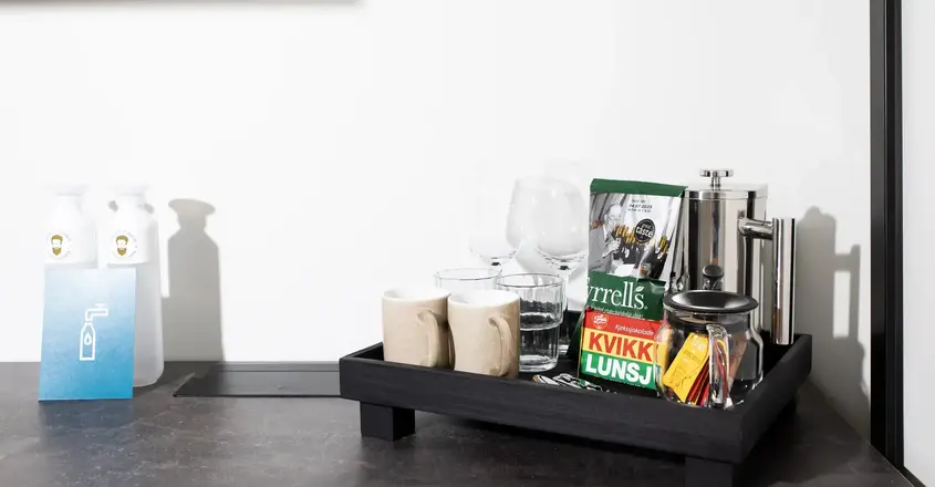 a tray with coffee cups and other items on it