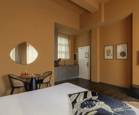 a room with a round mirror and a bed