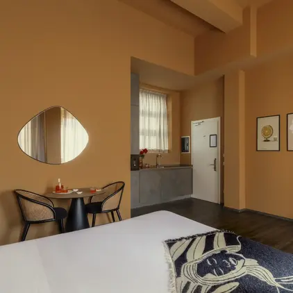 a room with a round mirror and a bed