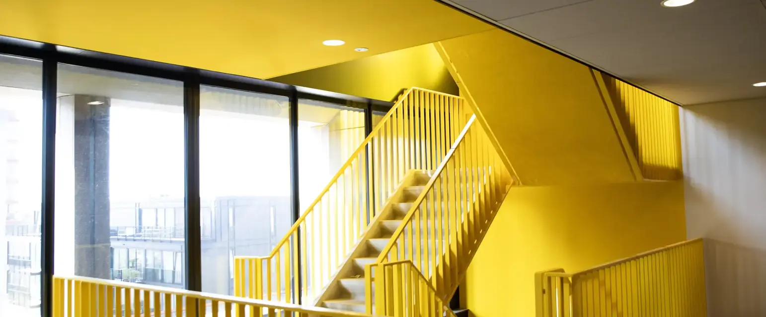 a yellow staircase in a building