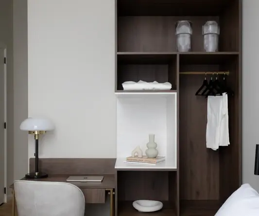 a room with a desk and shelves