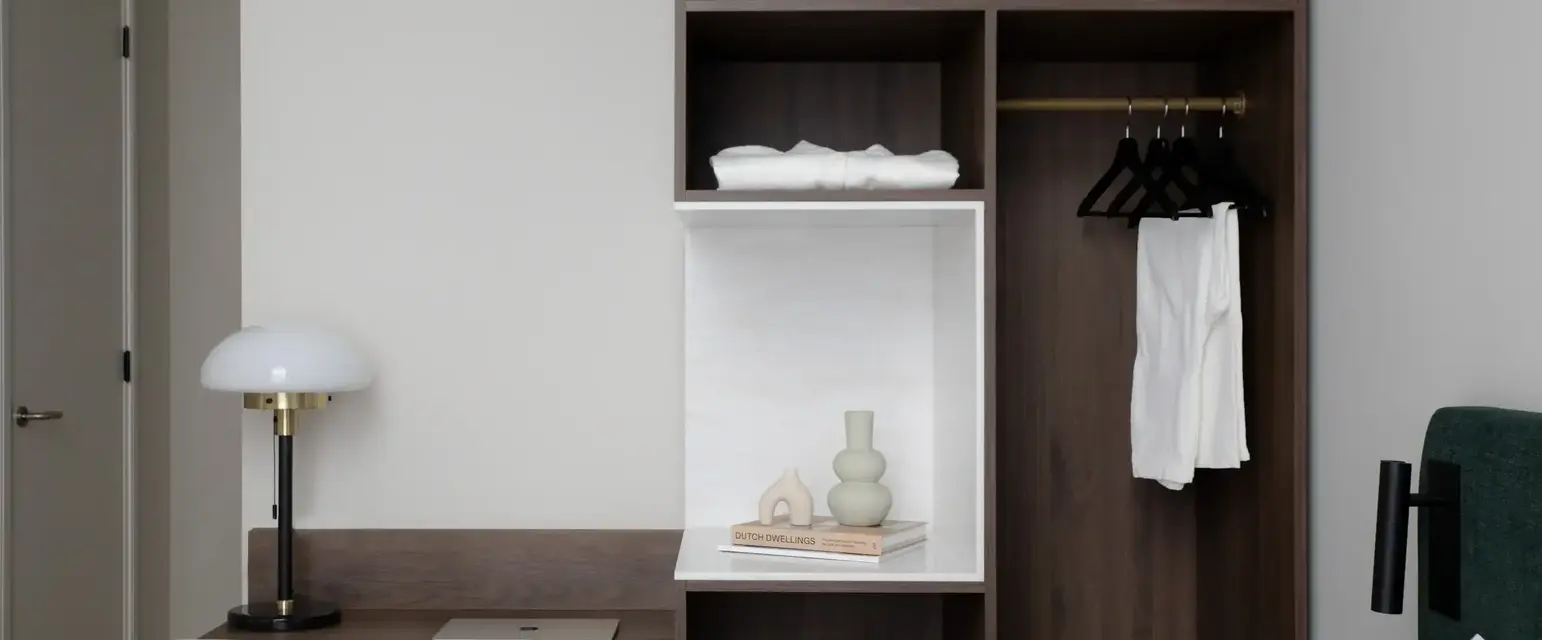 a room with a desk and shelves