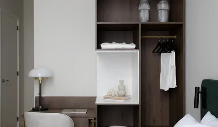 a room with a desk and shelves