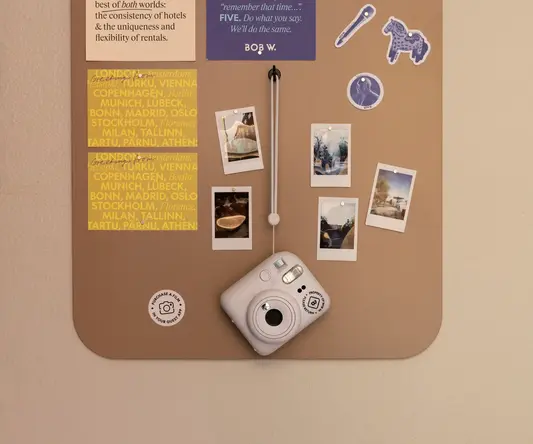 a white camera on a cork board