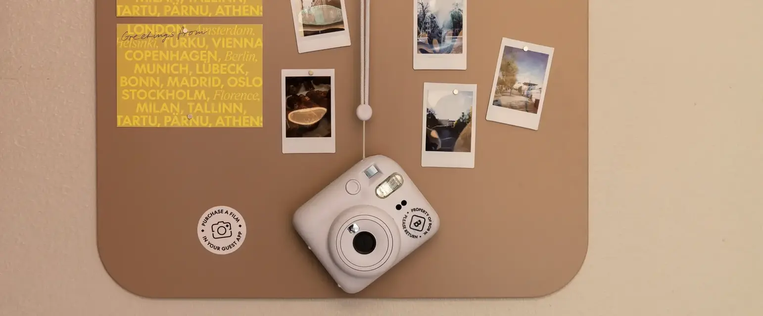 a white camera on a cork board