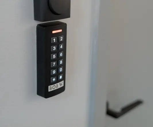 a black rectangular object with a keypad on the wall
