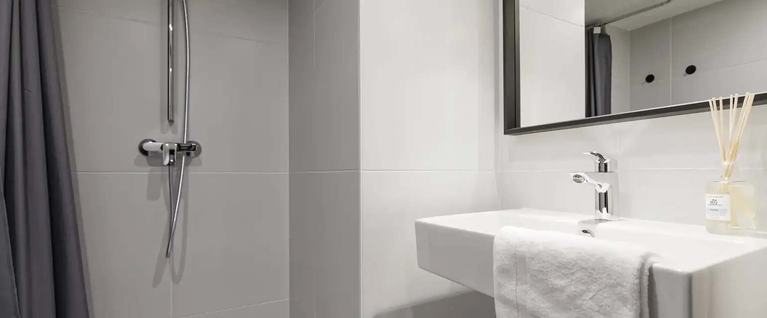 a bathroom with a shower and sink