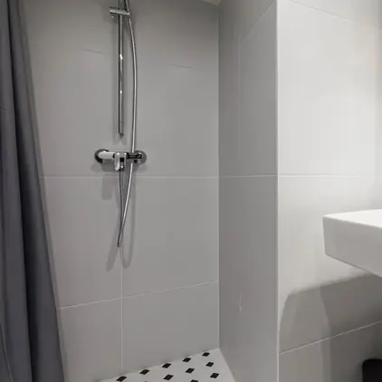 a bathroom with a shower and sink