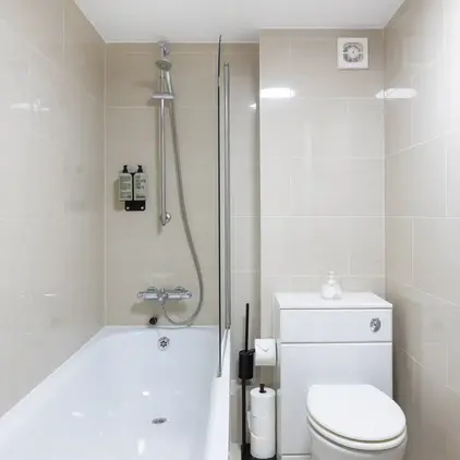 a bathroom with a toilet and tub