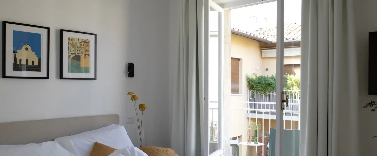 a bed with a door open to a balcony