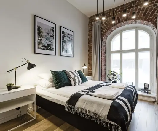 a bedroom with a bed and a window