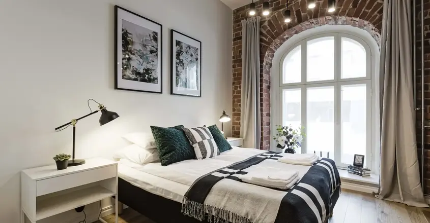 a bedroom with a bed and a window