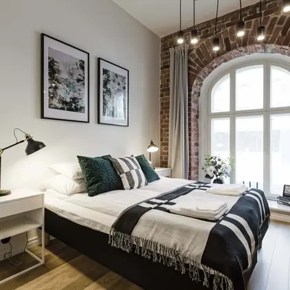 a bedroom with a bed and a window