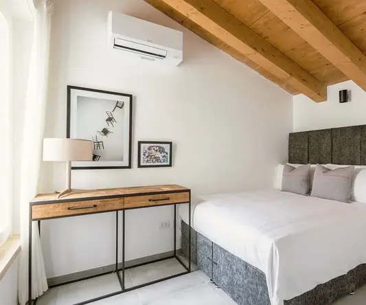 a bedroom with a bed and a desk