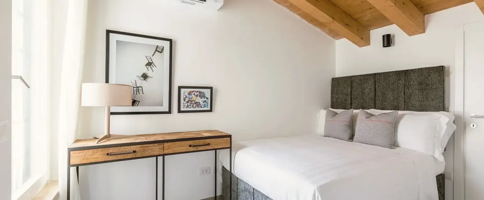 a bedroom with a bed and a desk